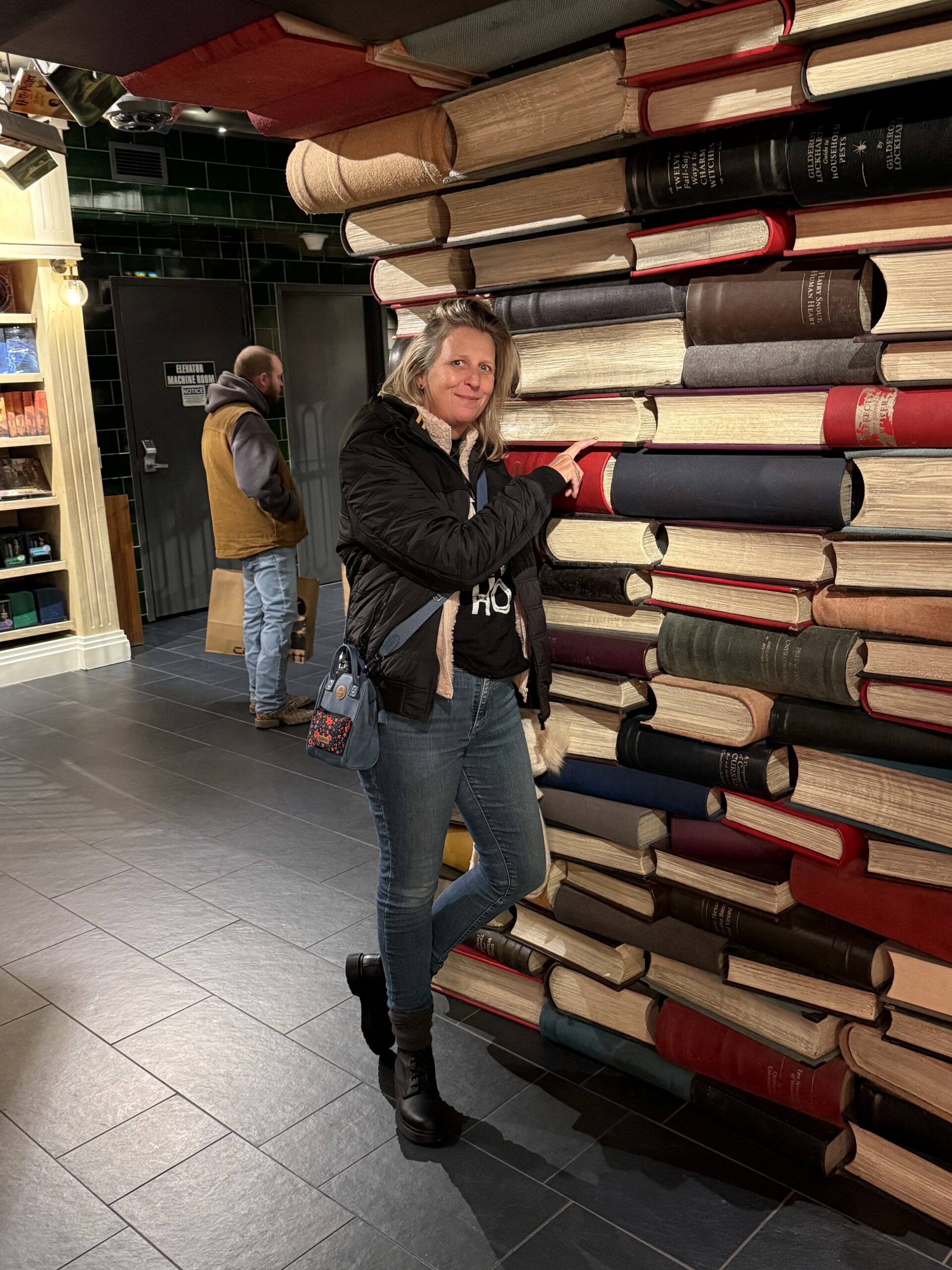 Brooklyn, New York — a woman standing next to a pile of books