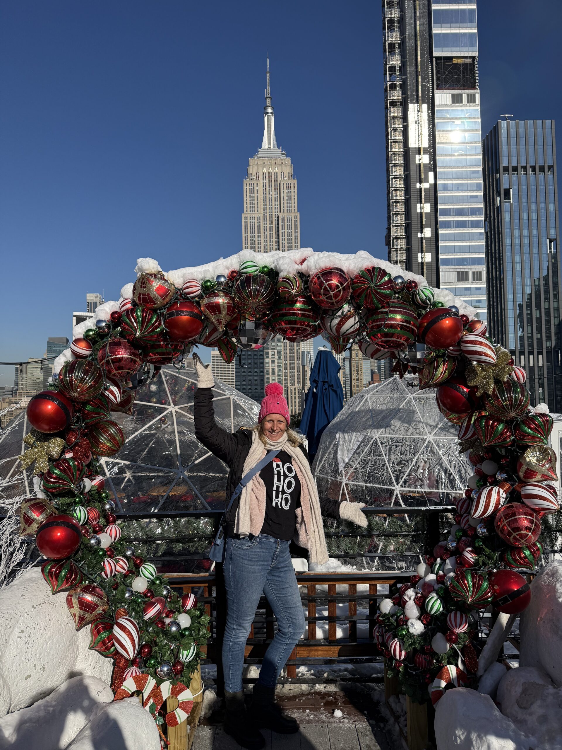 Brooklyn, New York — a woman standing in front of a christmas wreath