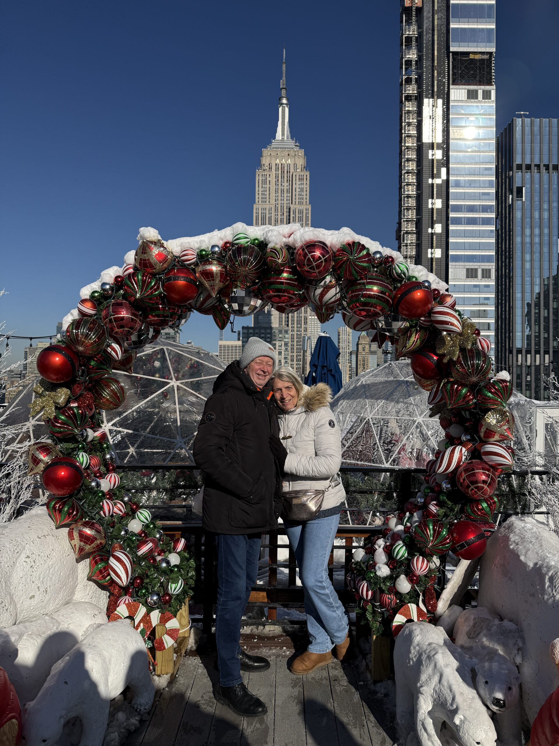 Brooklyn, New York — a man sitting on a bench with a bunch of christmas ornaments