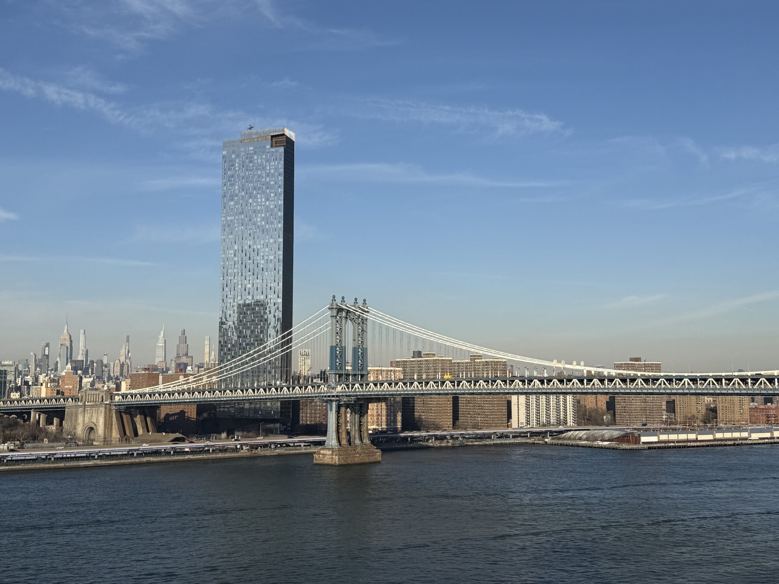 Brooklyn, New York — a bridge over a river with a city in the background
