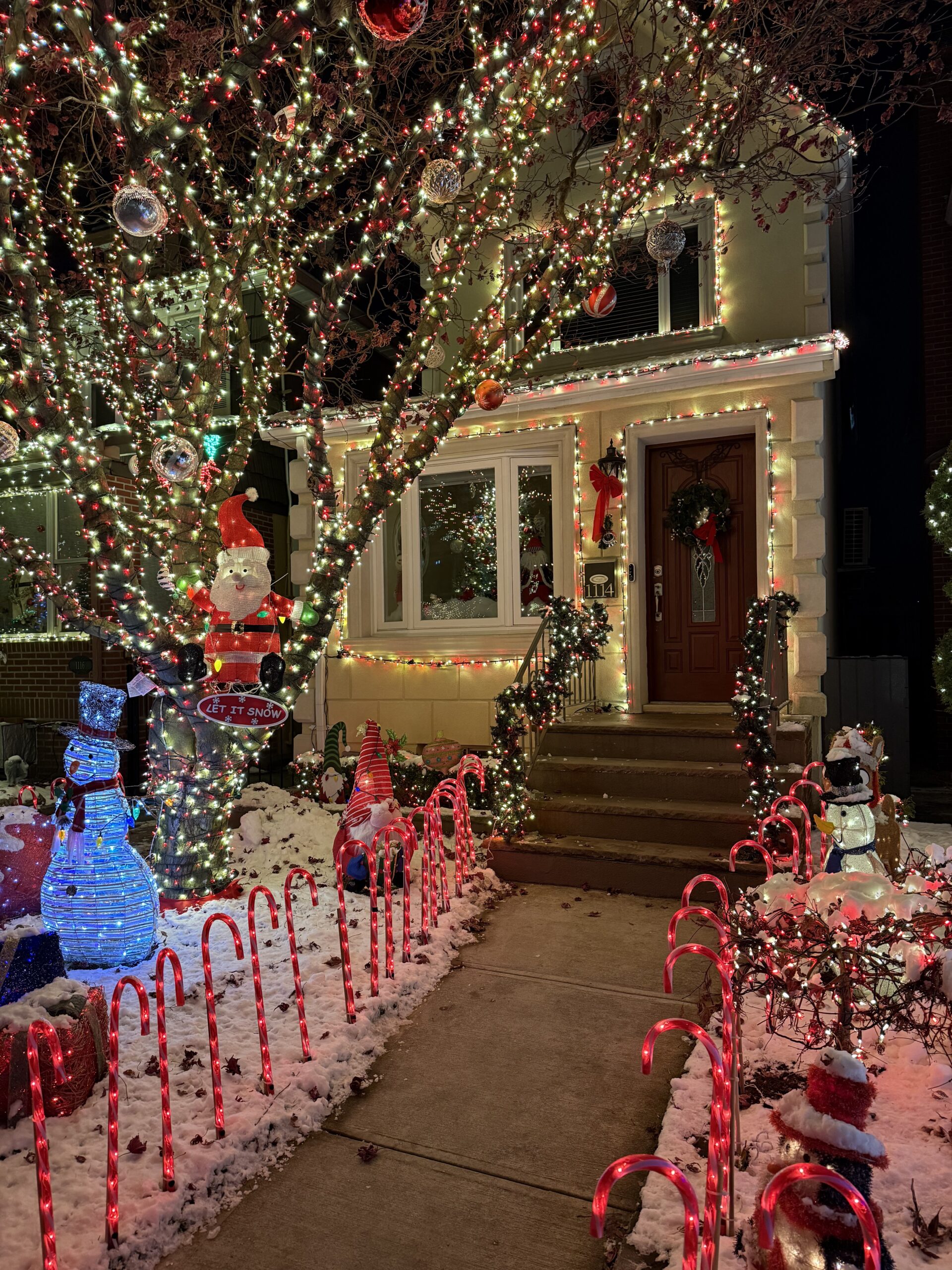 Brooklyn, New York — a house decorated for christmas with a snowman and candy canes