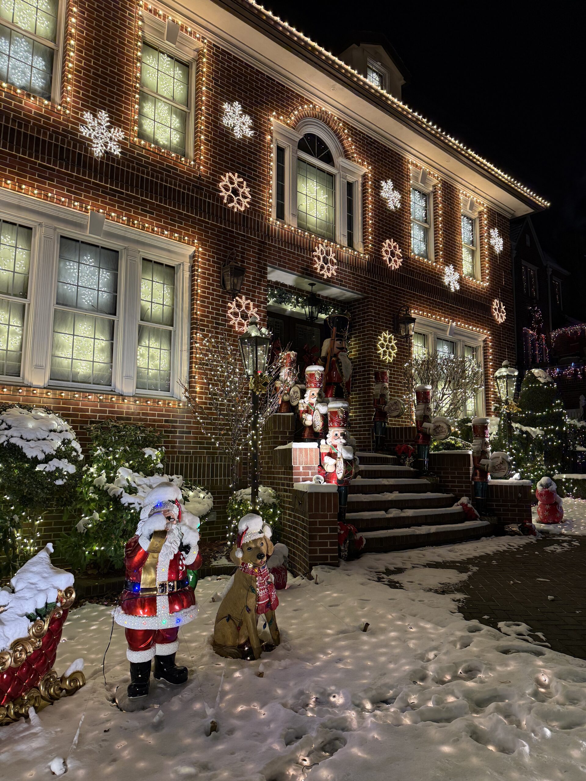 Brooklyn, New York — a house with a christmas tree and a couple of people outside