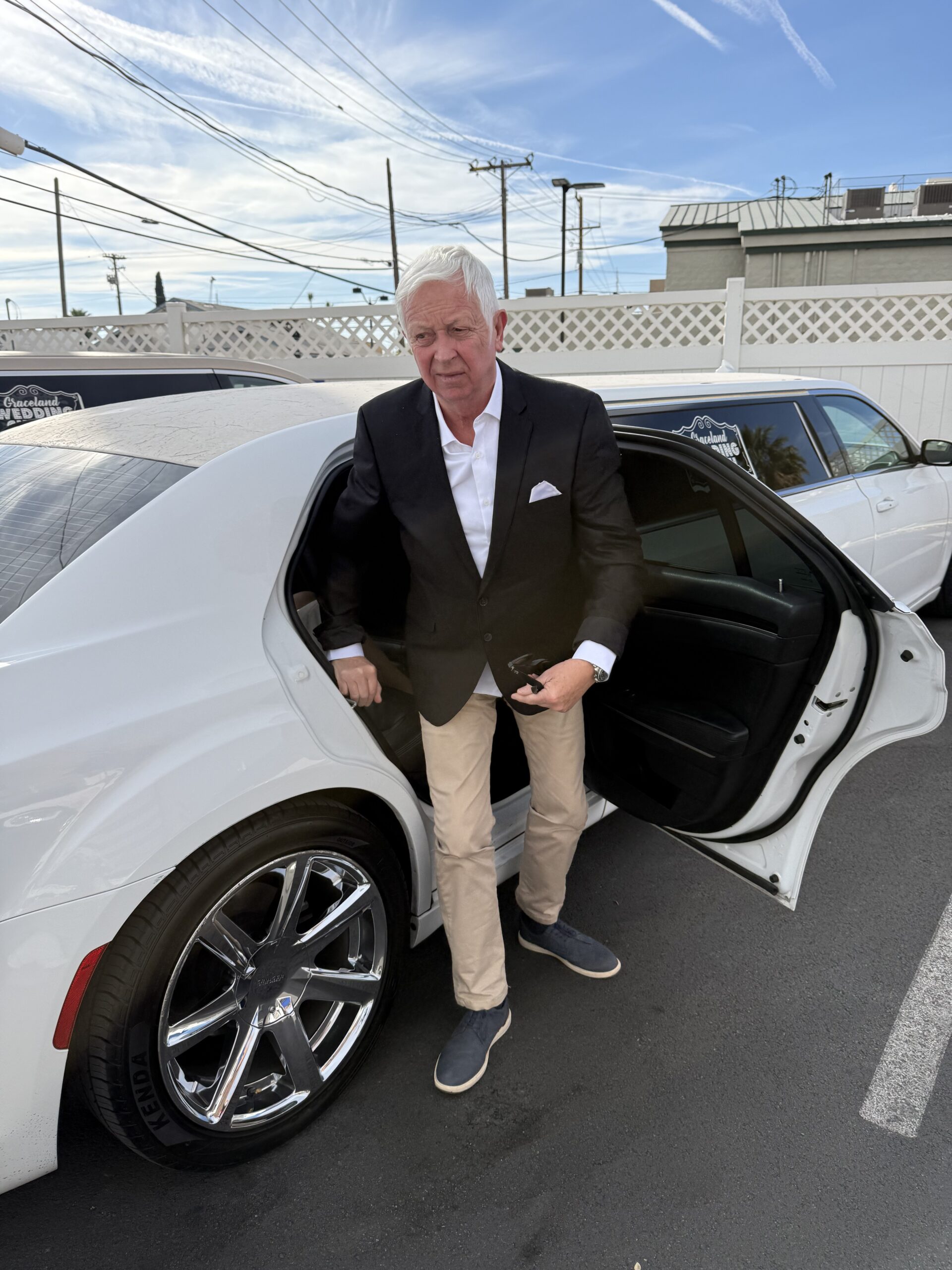 Downtown Las Vegas, Las Vegas — un homme en costume se penchant vers une voiture blanche