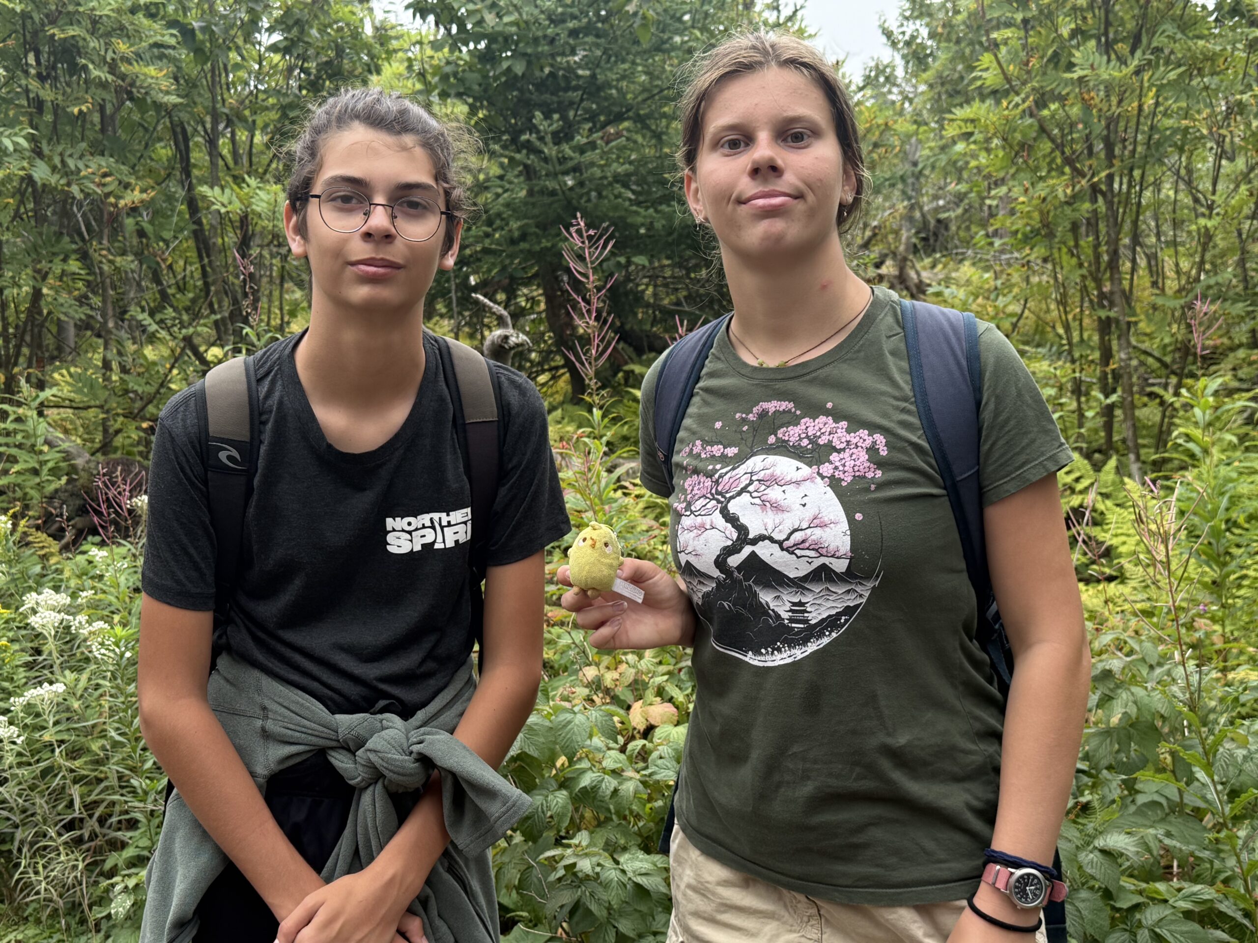 two girls standing in a forest with a banana, Percé, Québec, Canada