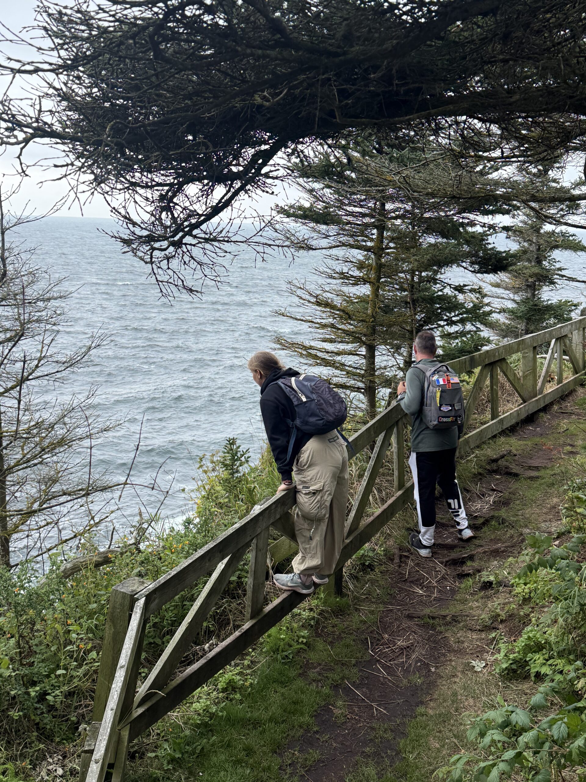 a couple of people walking up a path, Percé, Québec, Canada