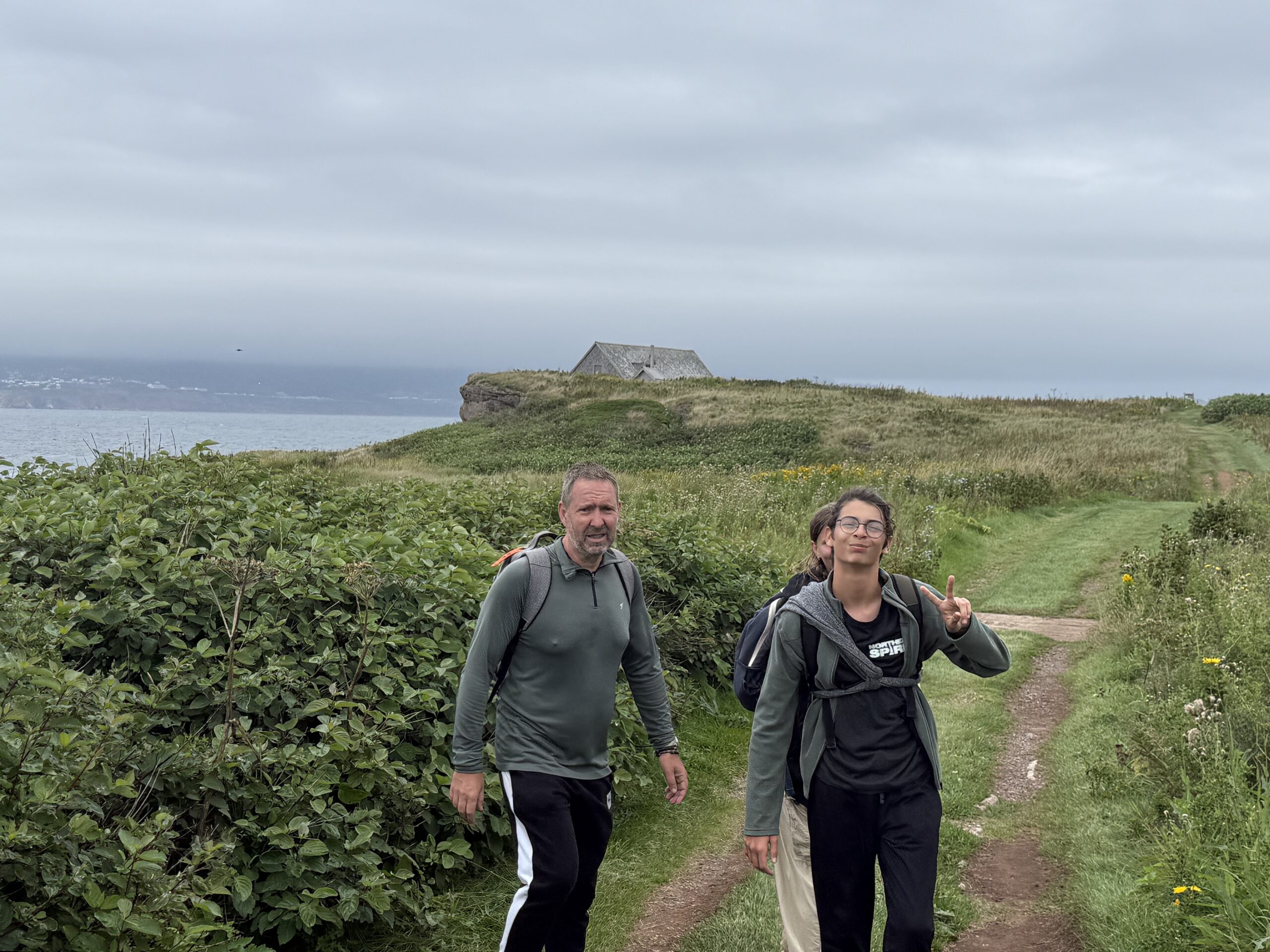 two people walking on a path near the ocean, Percé, Québec, Canada
