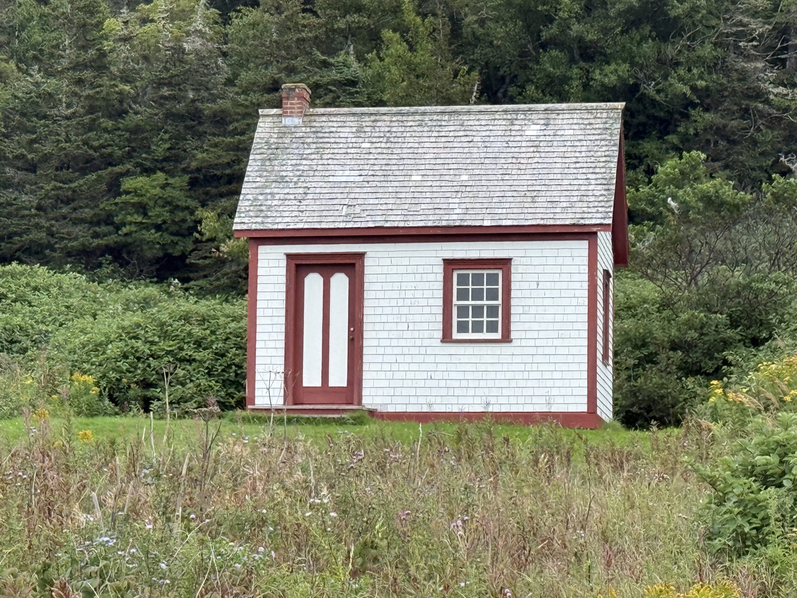 a small white house with a red roof, Percé, Québec, Canada