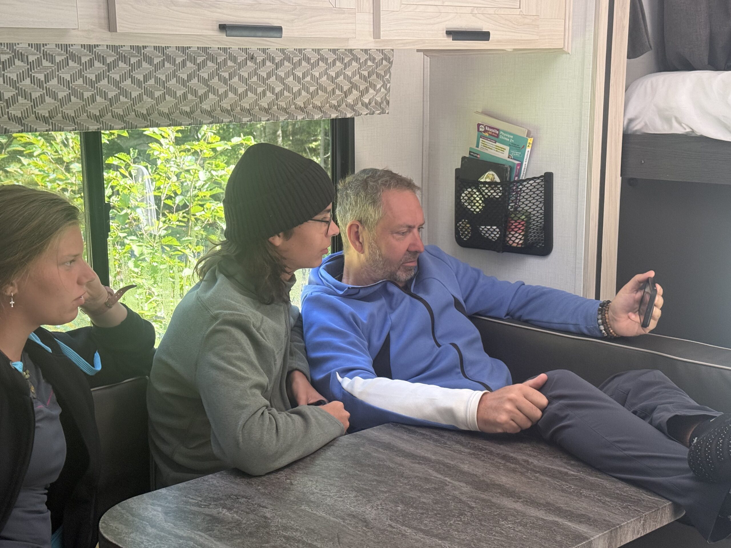 a man and woman sitting at a table in a bus, Port-Daniel, Québec, Canada