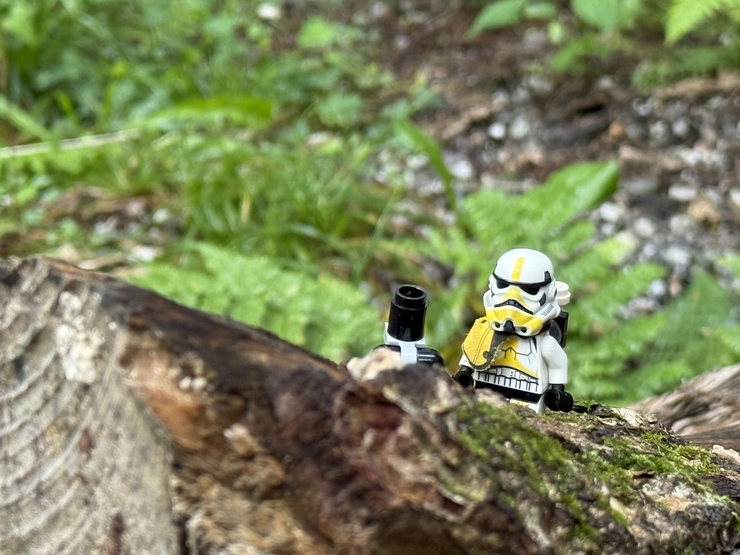 a lego figure is sitting on a log, Papineauville, Québec, Canada