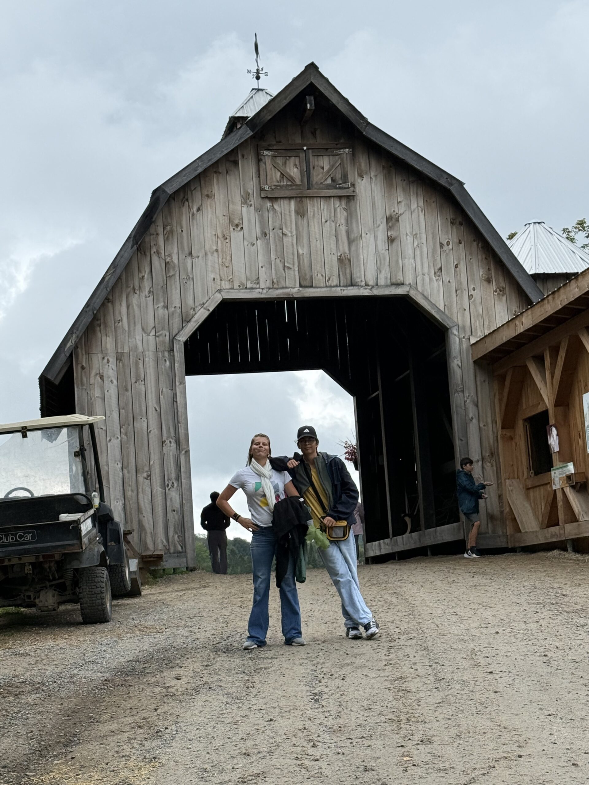 a couple of people standing in front of a barn, Papineauville, Québec, Canada