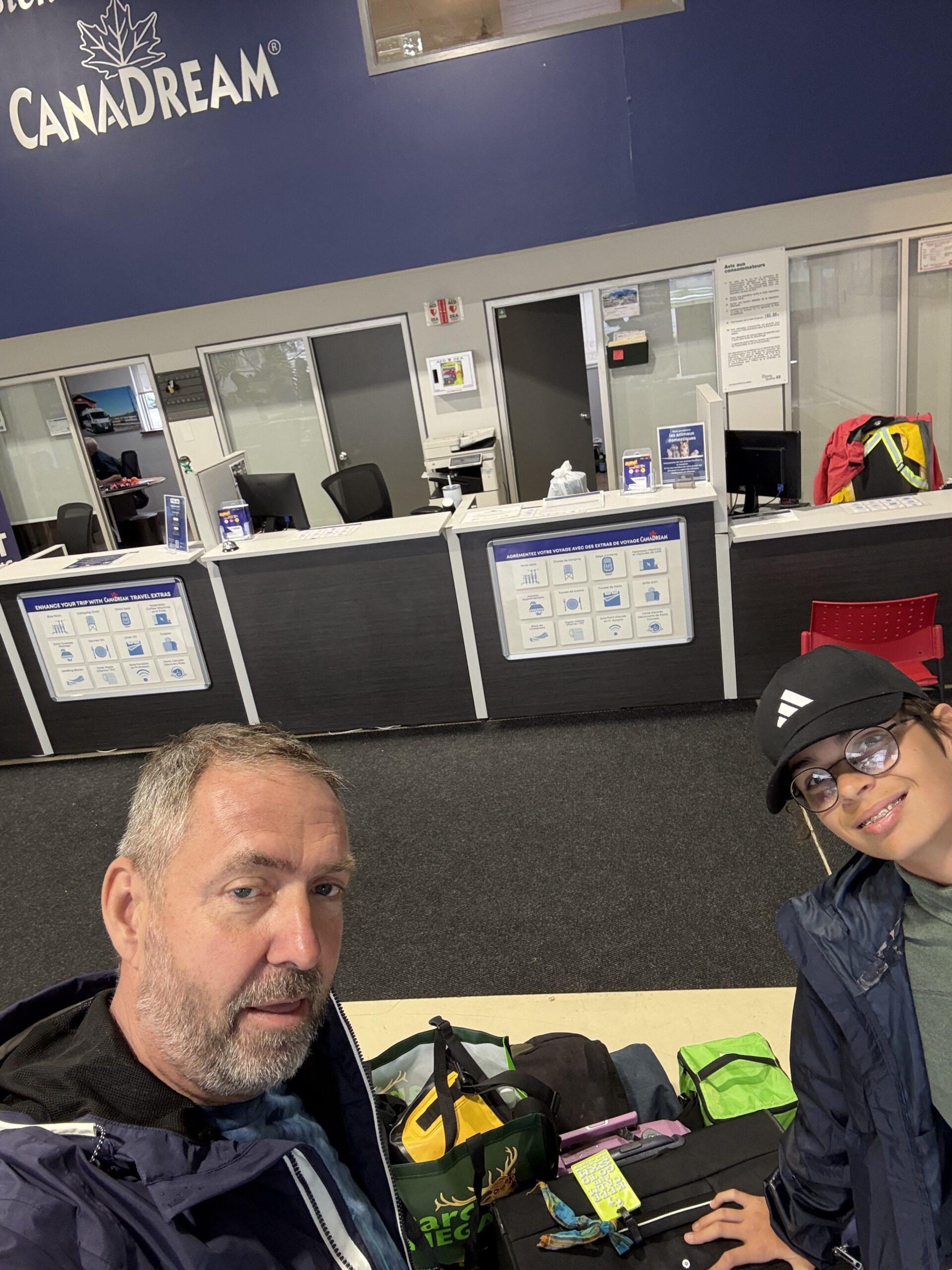 two people sitting at a table with luggage, Mirabel, Québec, Canada