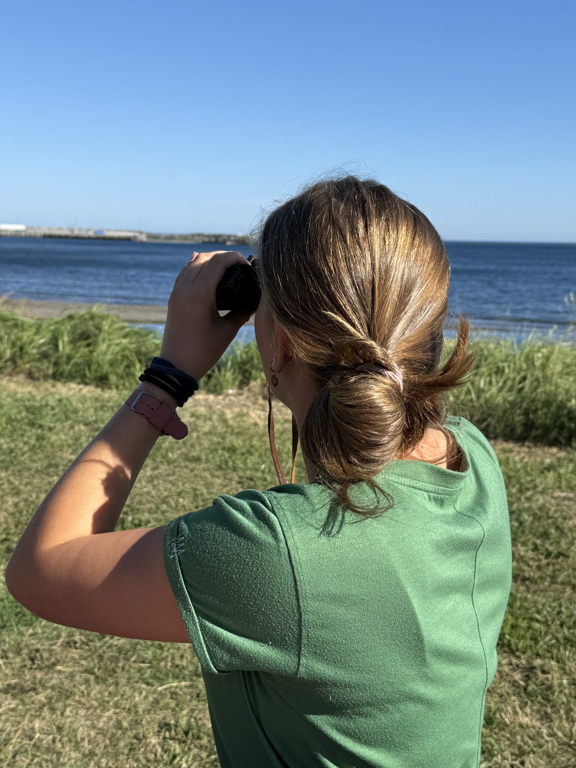 a woman looking at the ocean, Saint-Maxime-du-Mont-Louis, Québec, Canada