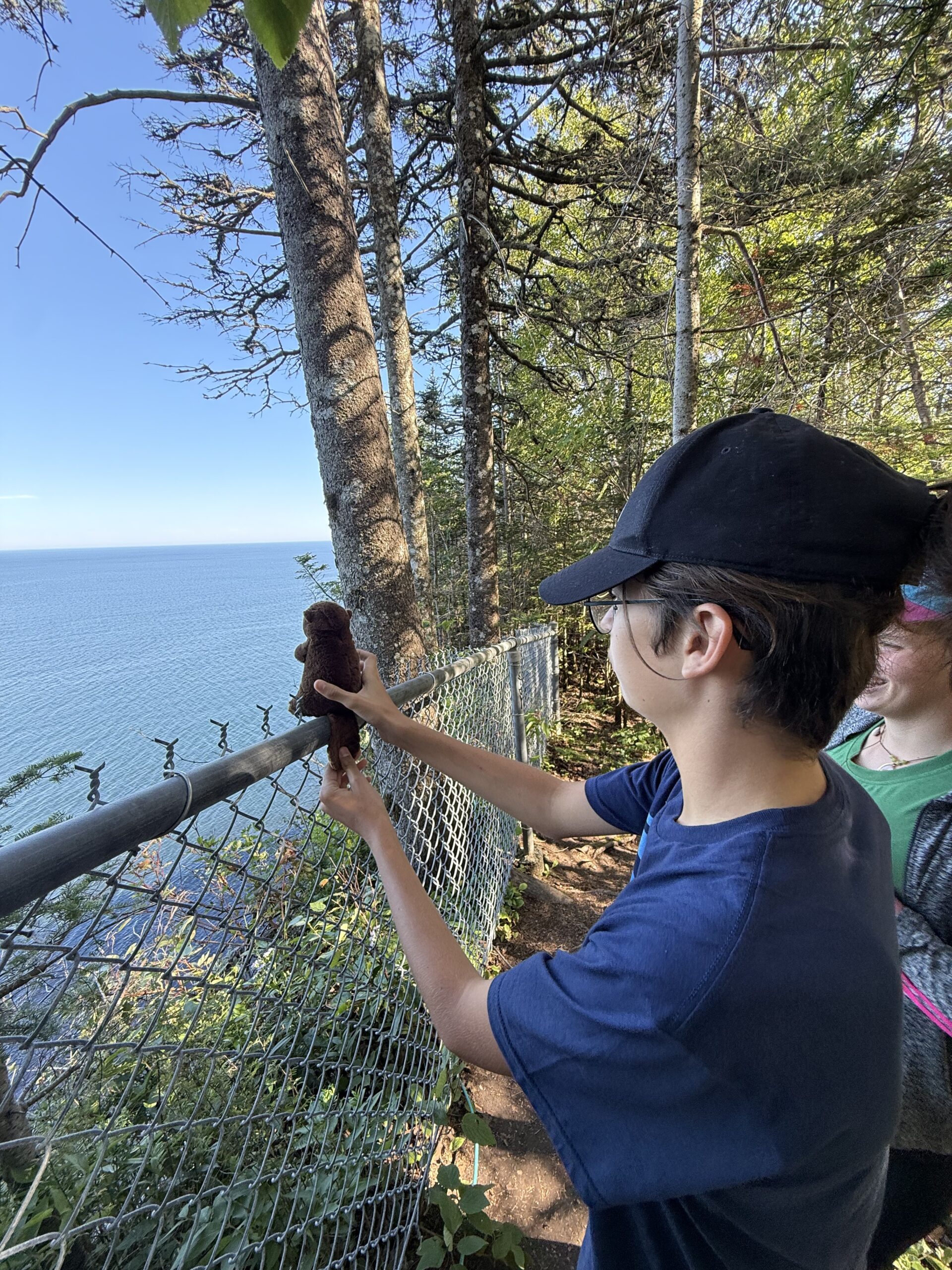 a woman and a child looking at a bird, Gaspé, Québec, Canada