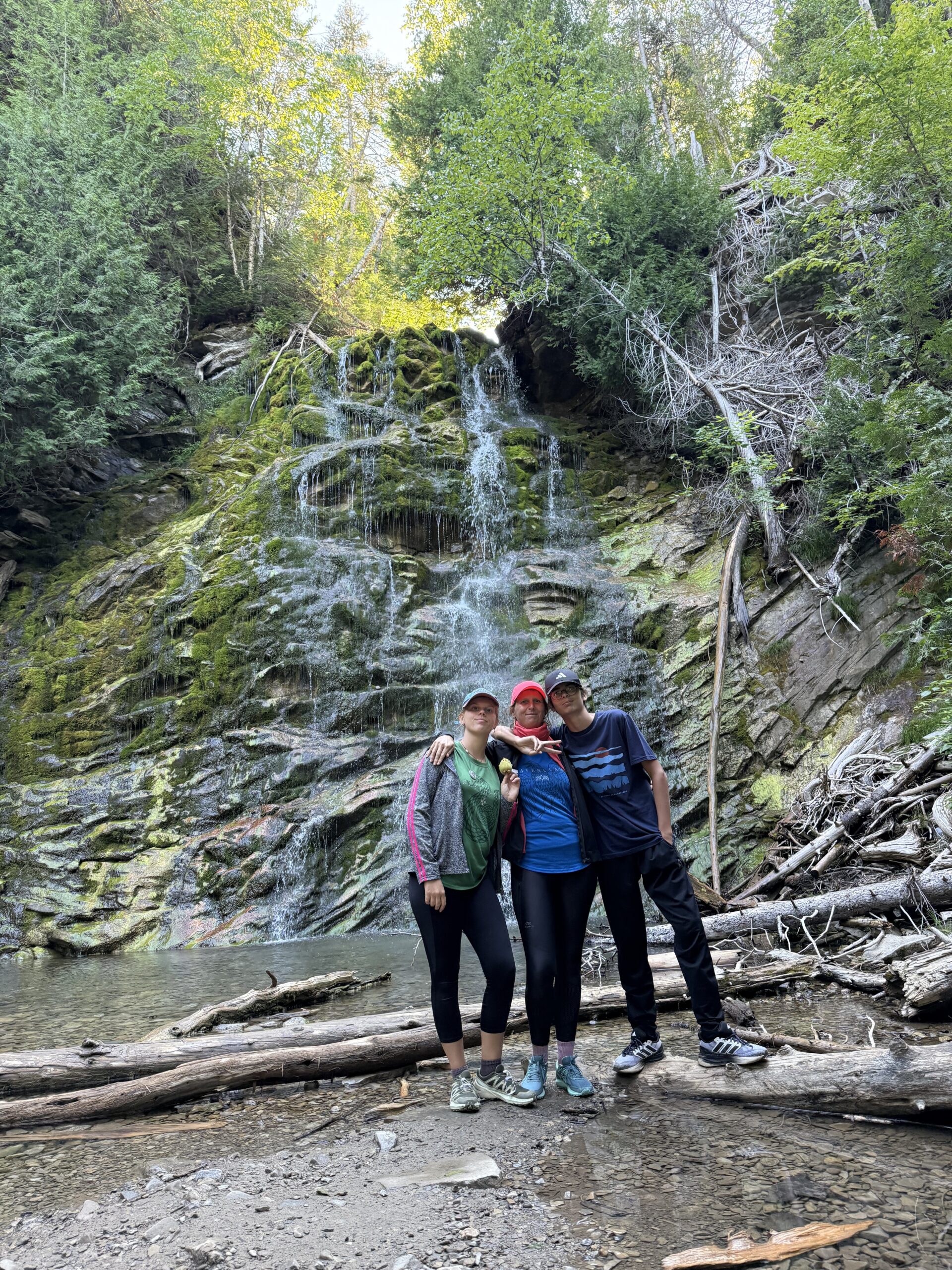 two people standing in front of a waterfall, Gaspé, Québec, Canada