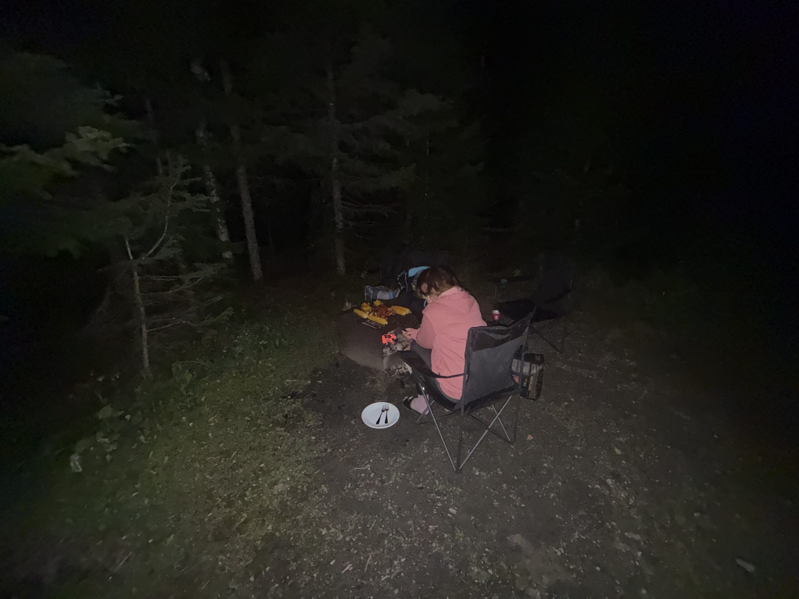 a person sitting in a chair in the woods, Gaspé, Québec, Canada
