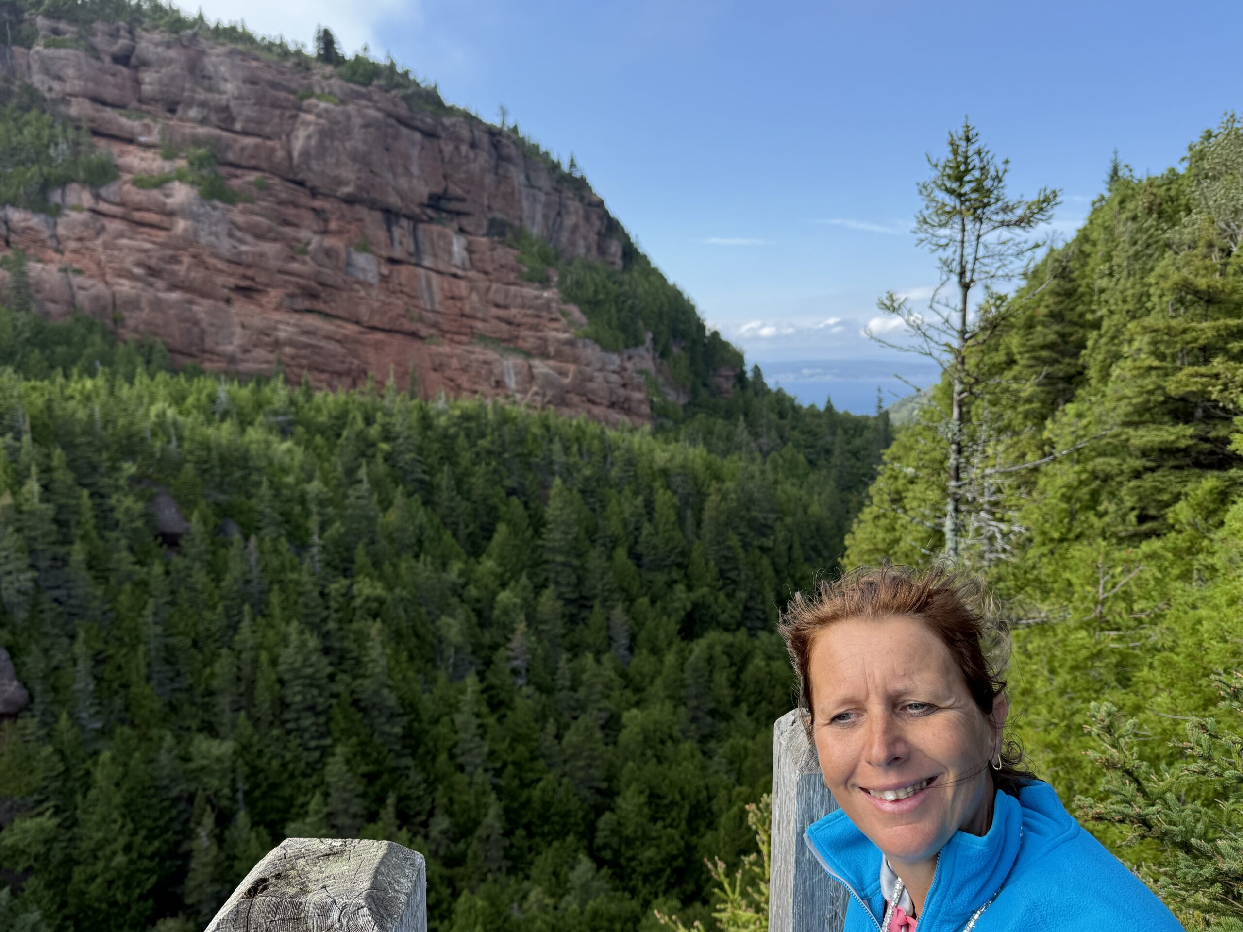 a woman standing on a rock, Percé, Québec, Canada
