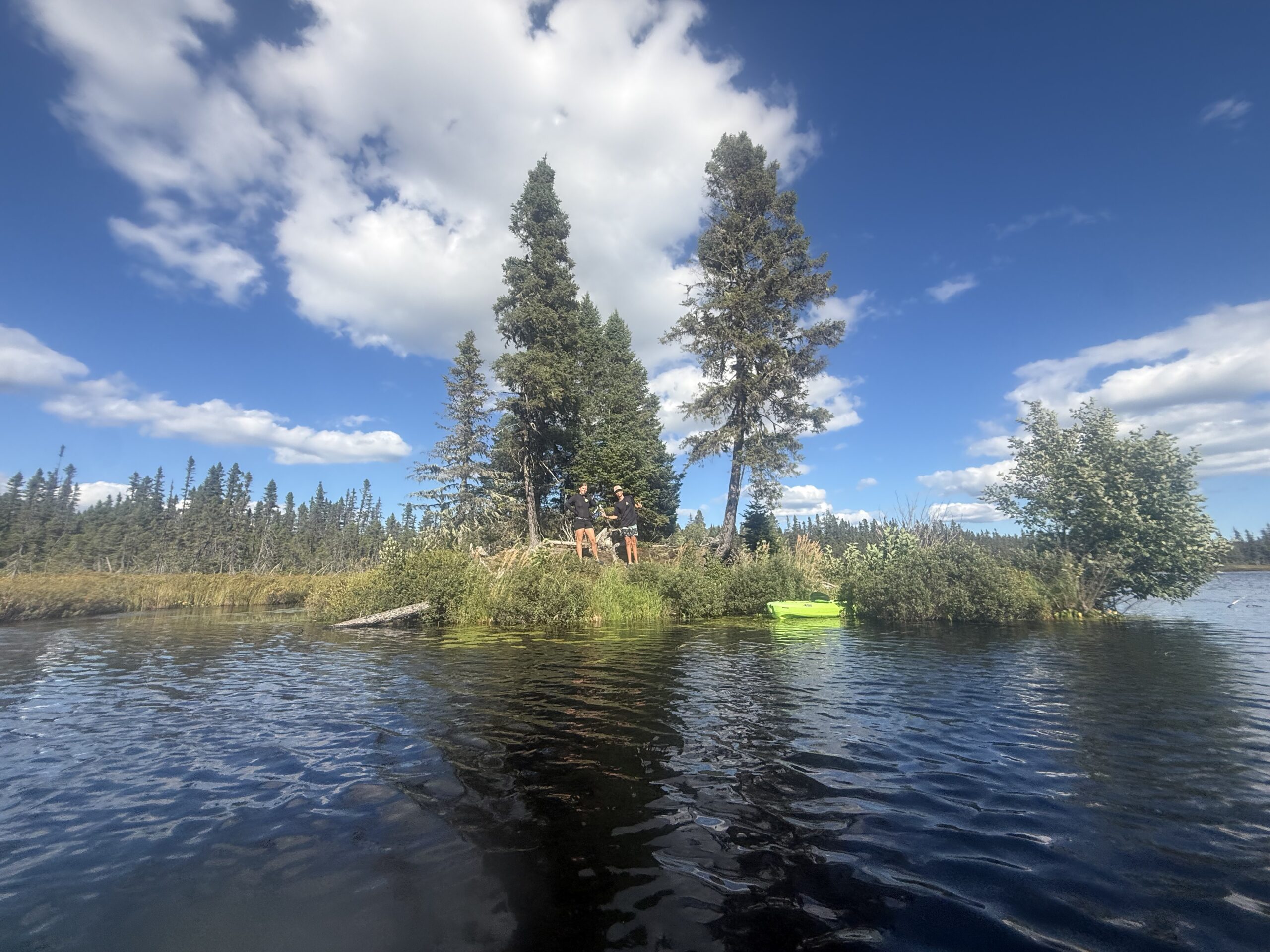 a man is paddling on a small island, Port-Daniel, Québec, Canada
