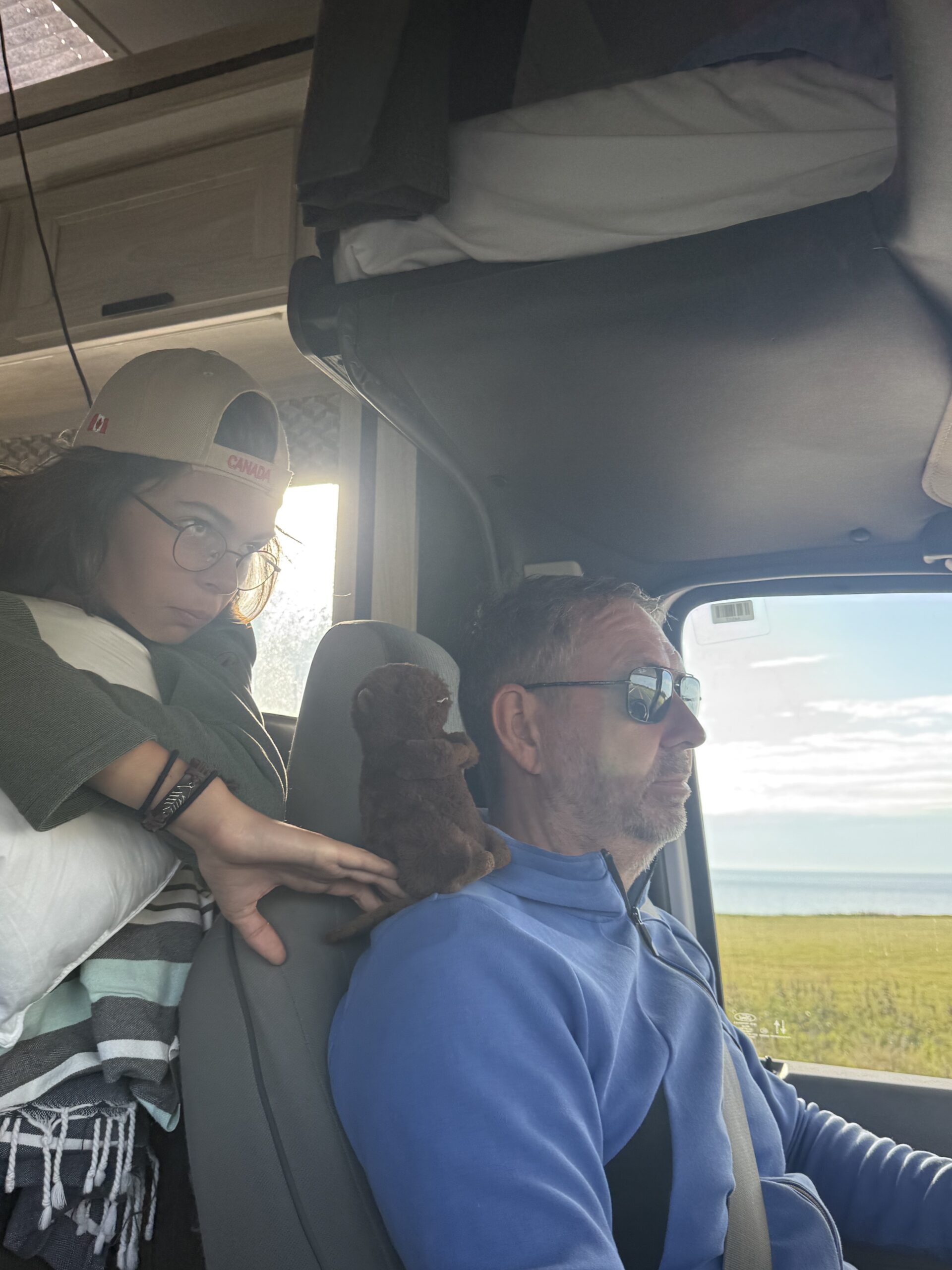 a man and woman in a car with a dog, Shigawake, Québec, Canada