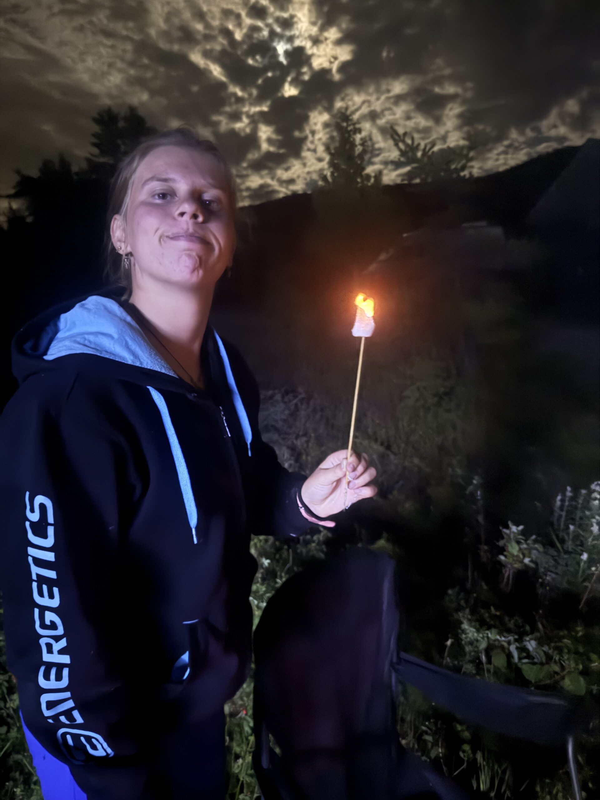 a woman holding a lit candle in her hand, Rimouski, Québec, Canada