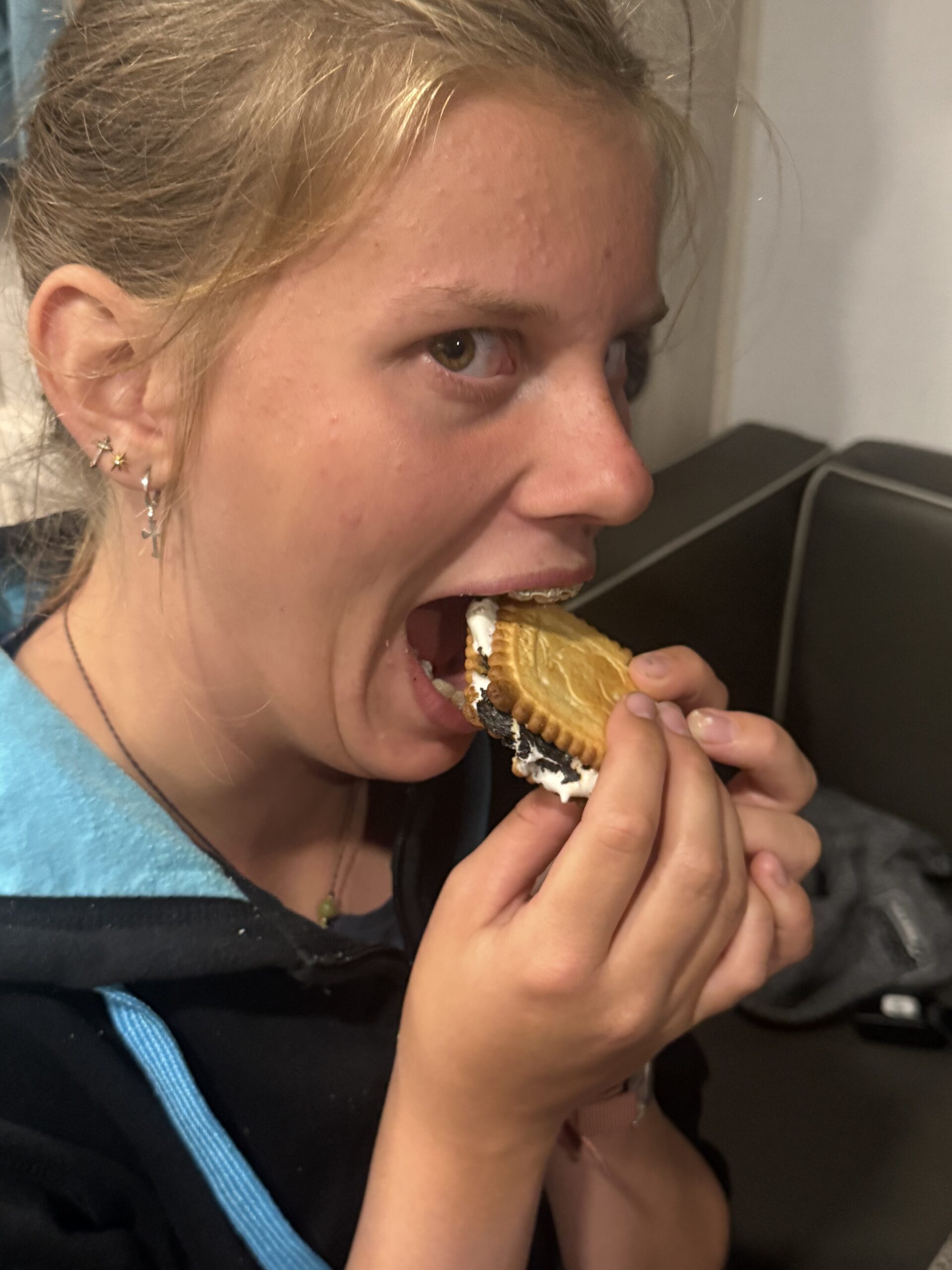 a woman eating a dough with a bite, Rimouski, Québec, Canada