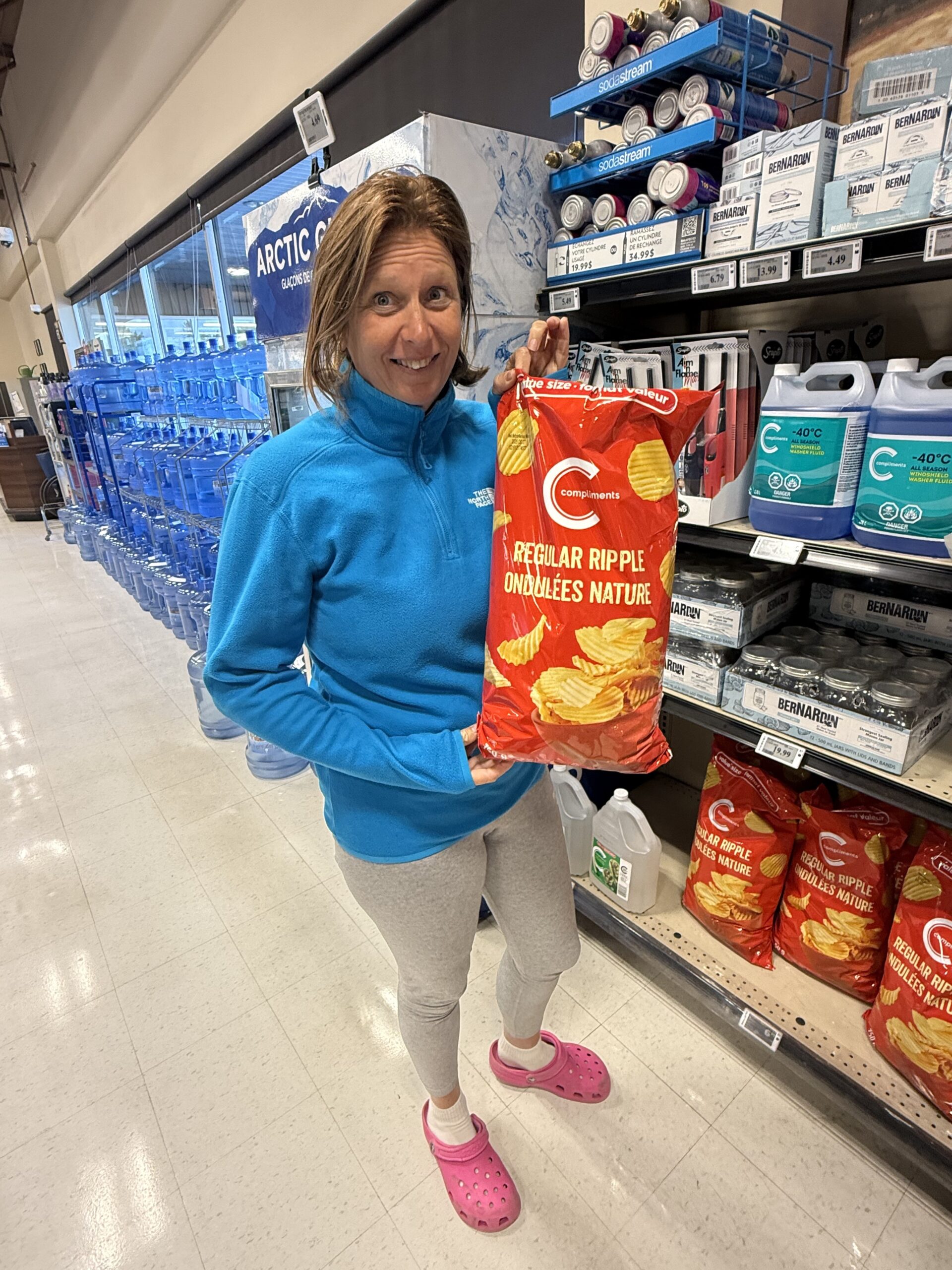 a woman holding a bag of chips, New Richmond, Québec, Canada