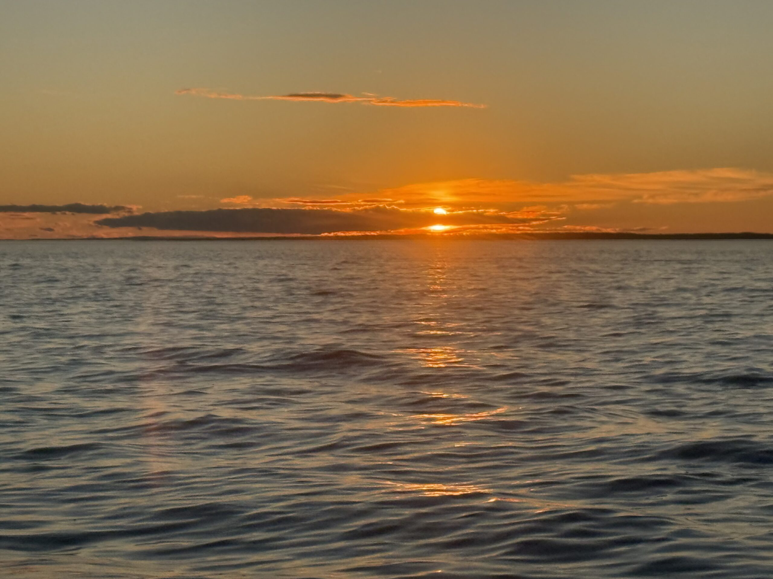 the sun is setting over the water, Rimouski, Québec, Canada