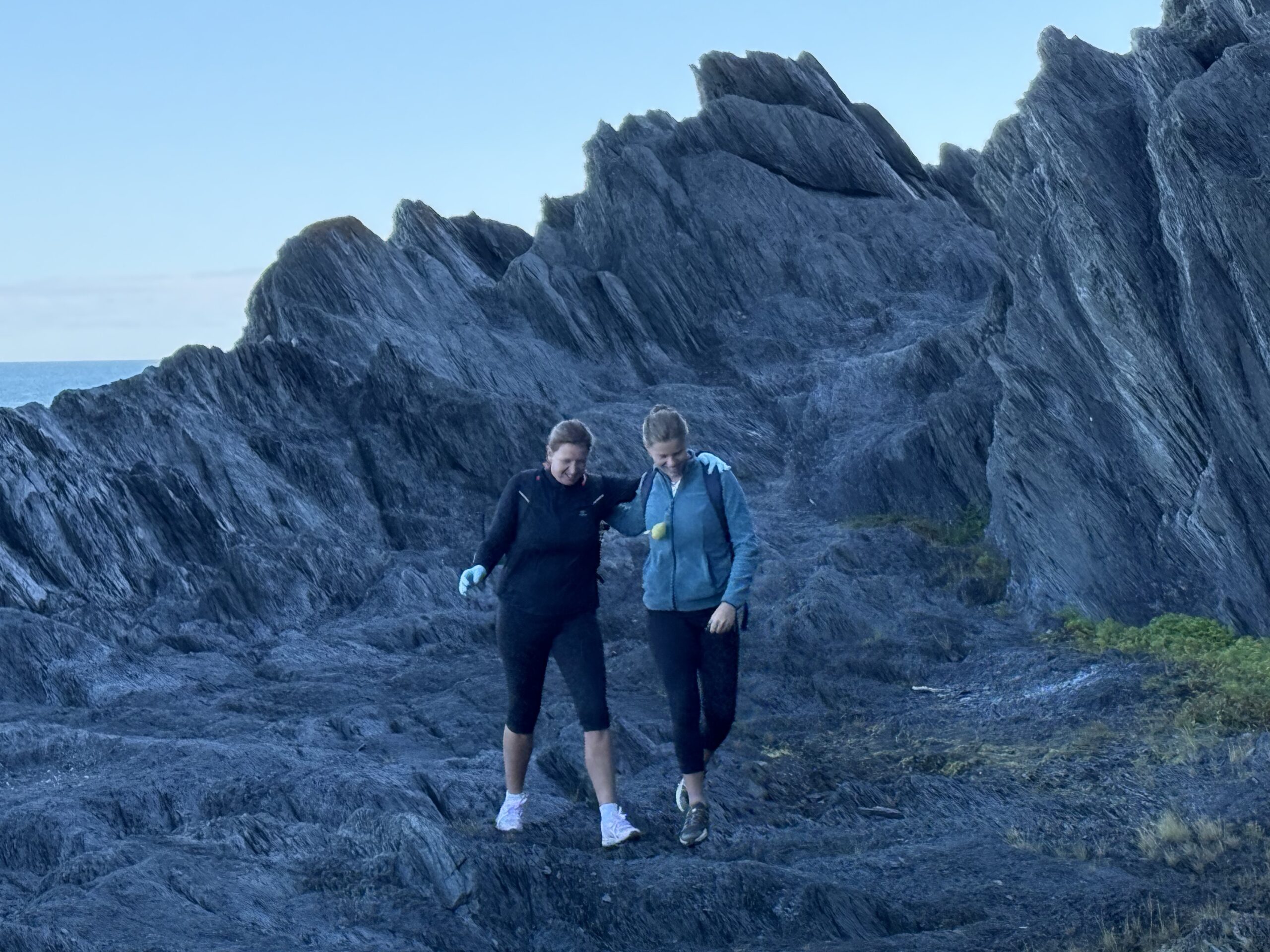 two people standing on a rocky cliff, Rimouski, Québec, Canada