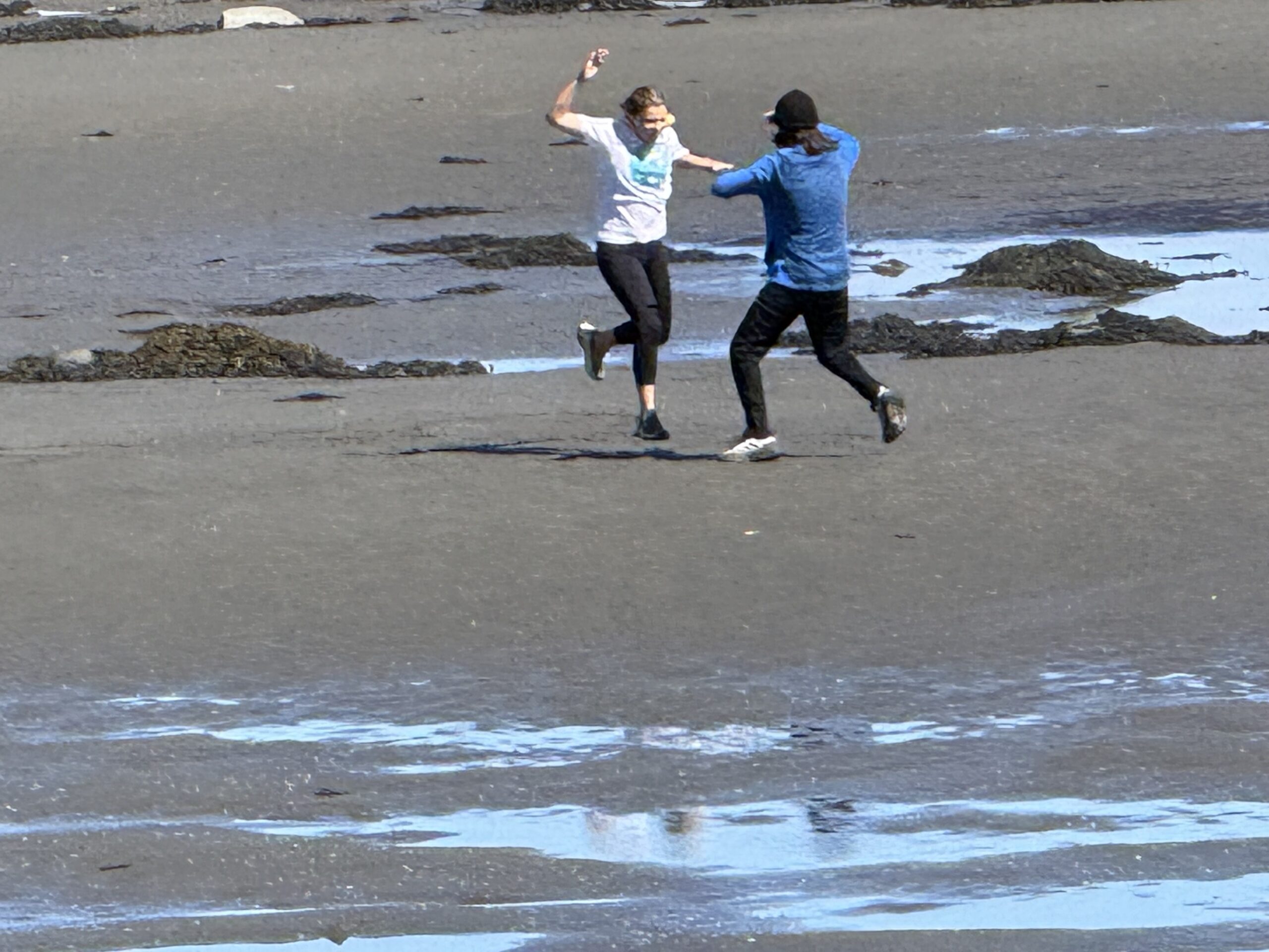 two people are playing on the beach, Rimouski, Québec, Canada