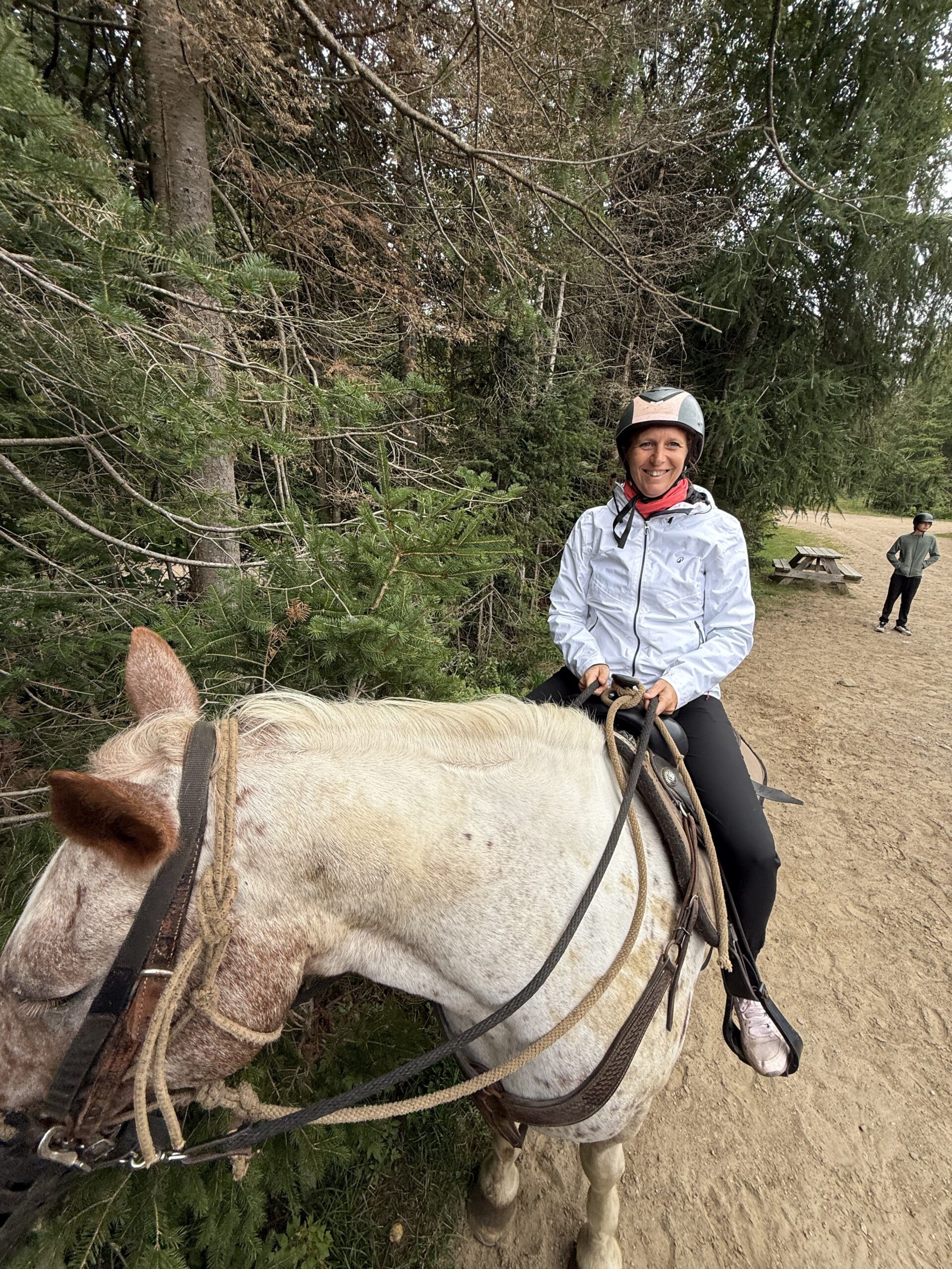 a woman riding a horse on a dirt road, Val-des-Lacs, Québec, Canada