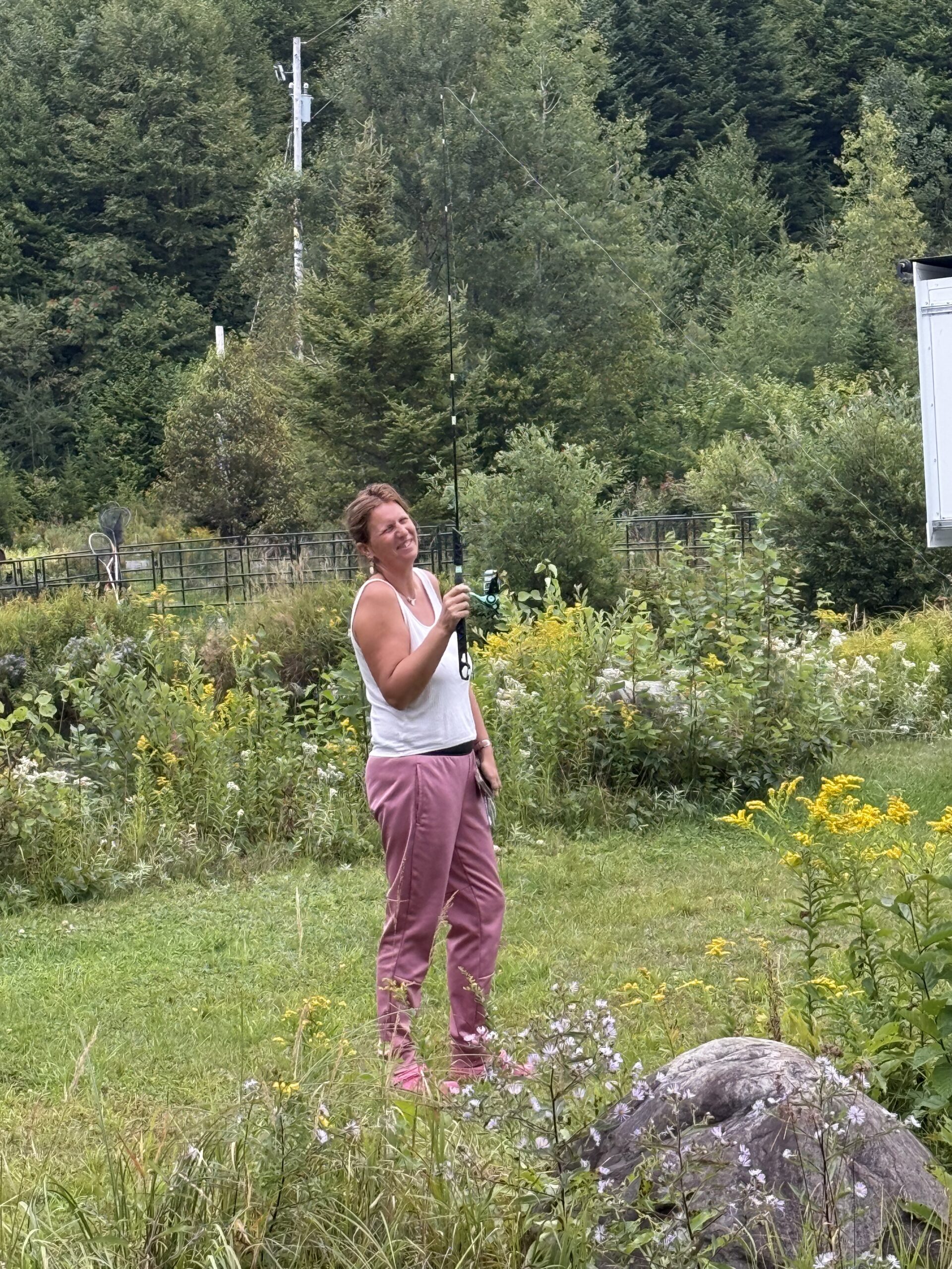 a woman standing in a field with a cell, Val-des-Lacs, Québec, Canada