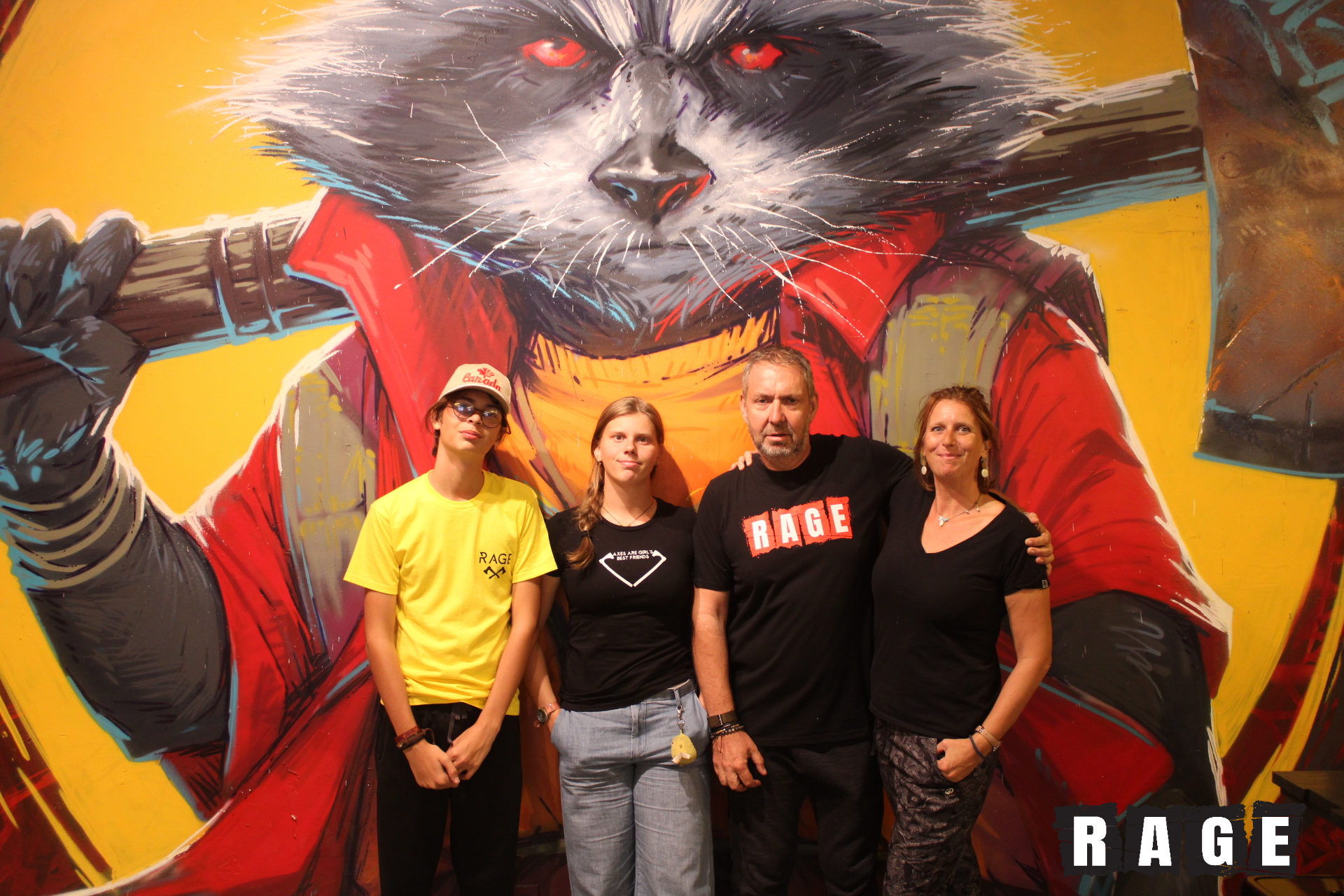 a group of people standing in front of a painting