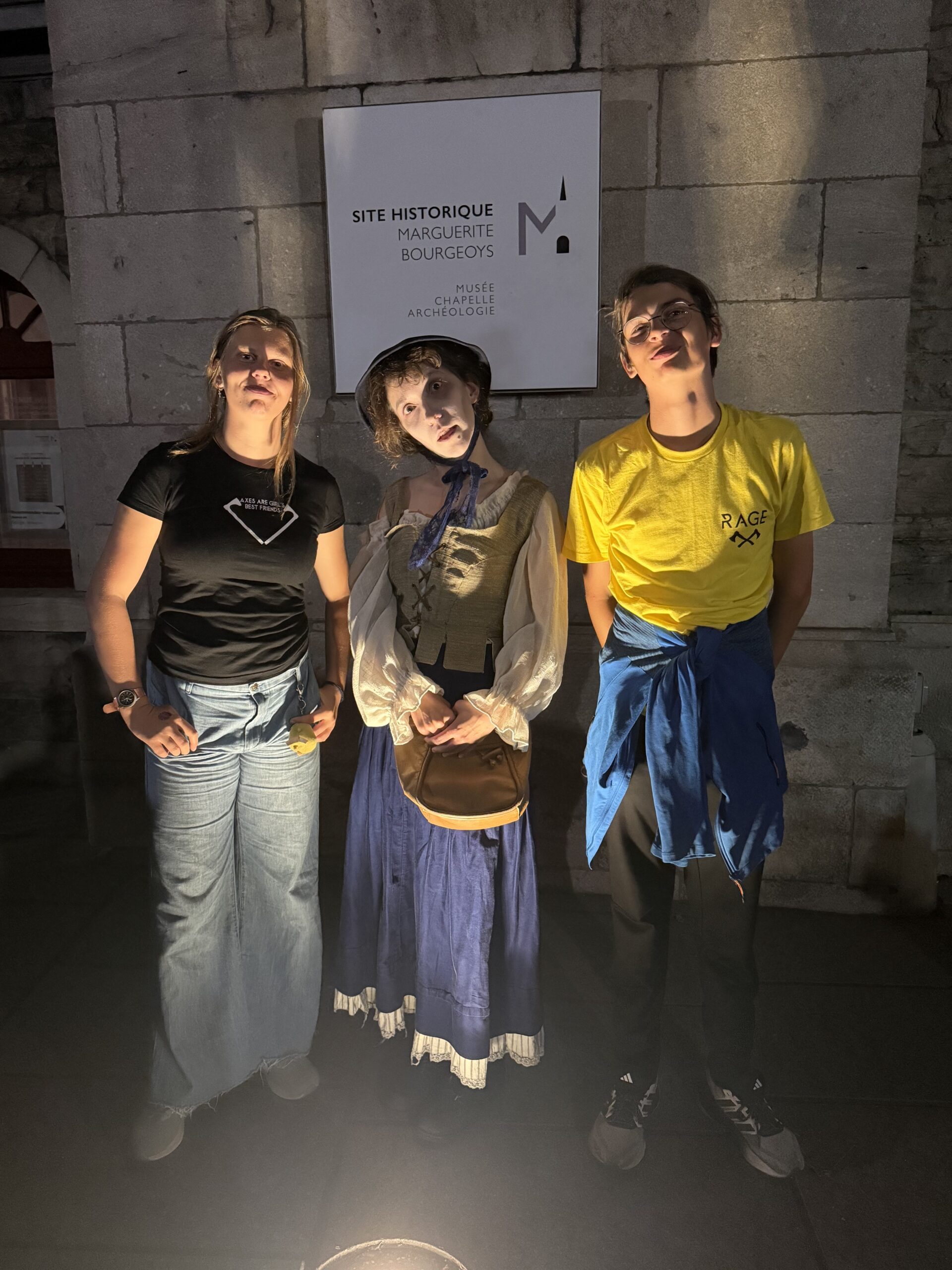 three people standing next to a sign that says ' the museum ', Montréal, Québec, Canada