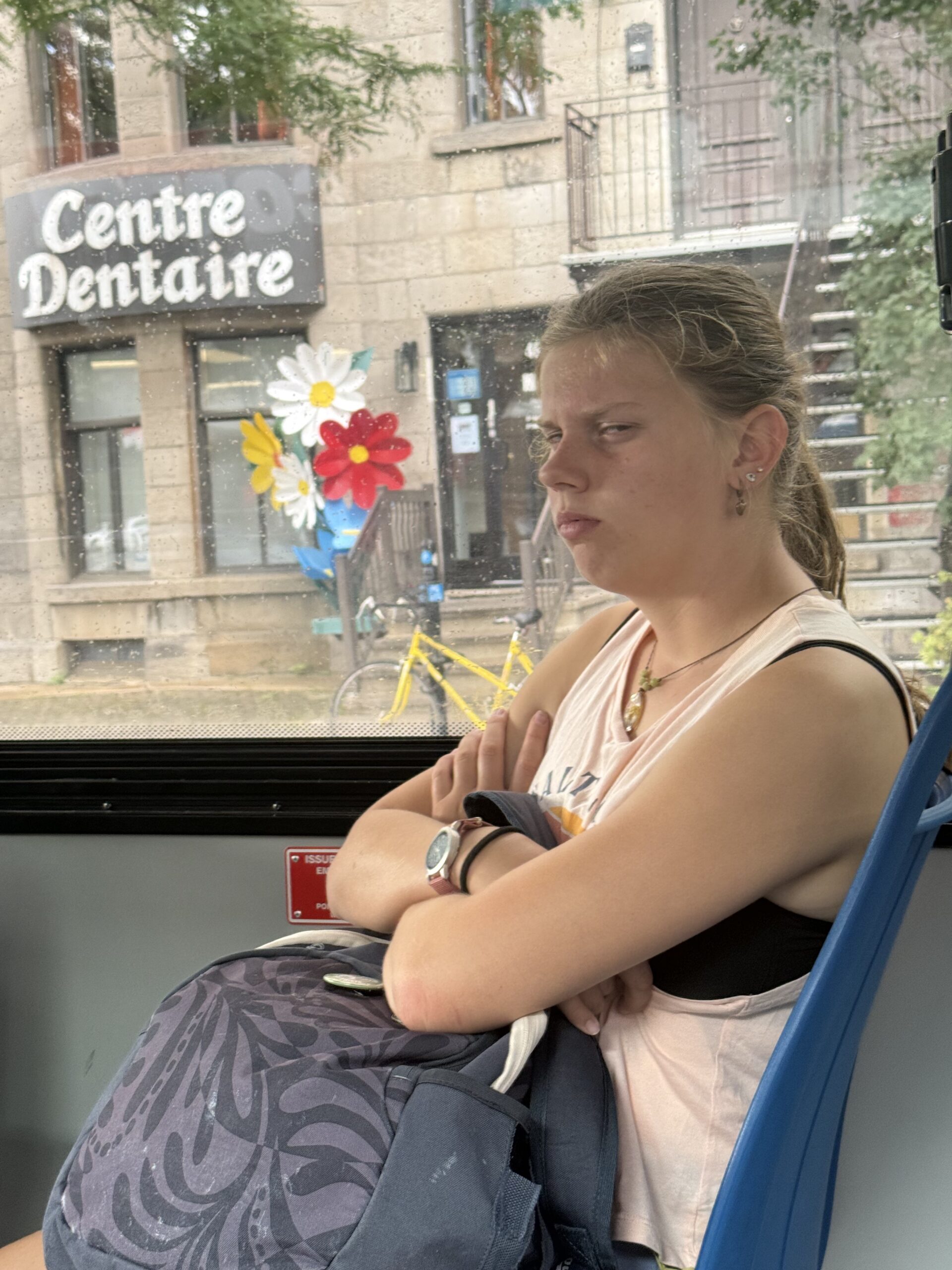 a girl sitting on a bus with a cell, Montréal, Québec, Canada